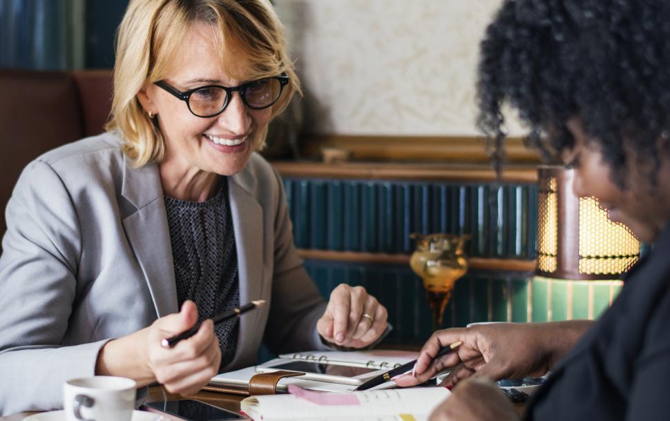 Free Image of A women at a cafe doing business 