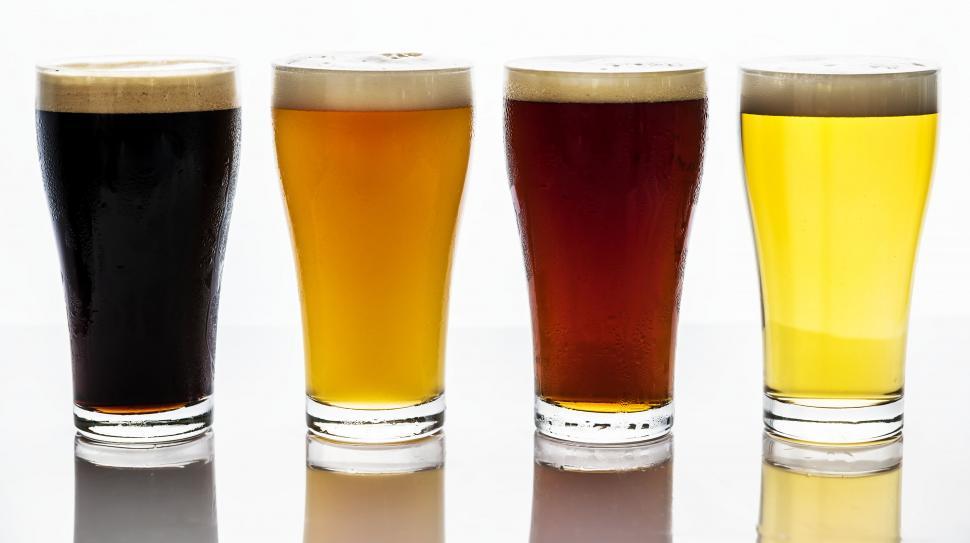 Free Stock Photo of Close up of four beers served in pint glasses