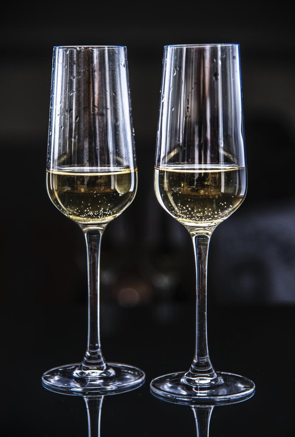 Close up of two partially filled champagne glasses