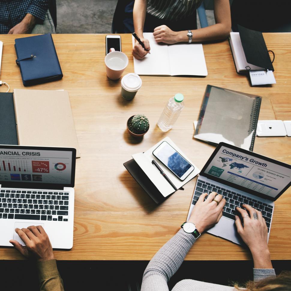 Free Image of Overhead view of a meeting table in the office with many devices 