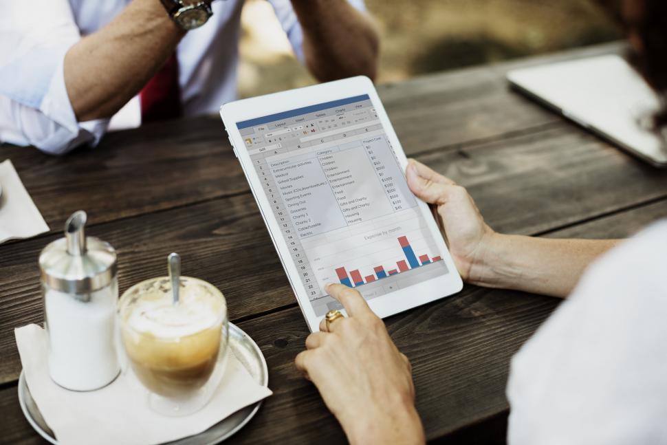 Free Image of Close up of a tablet PC used at a table over food and coffee 