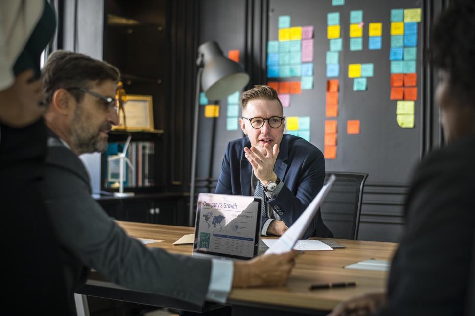 Free Image of Colleagues converse in a business meeting 