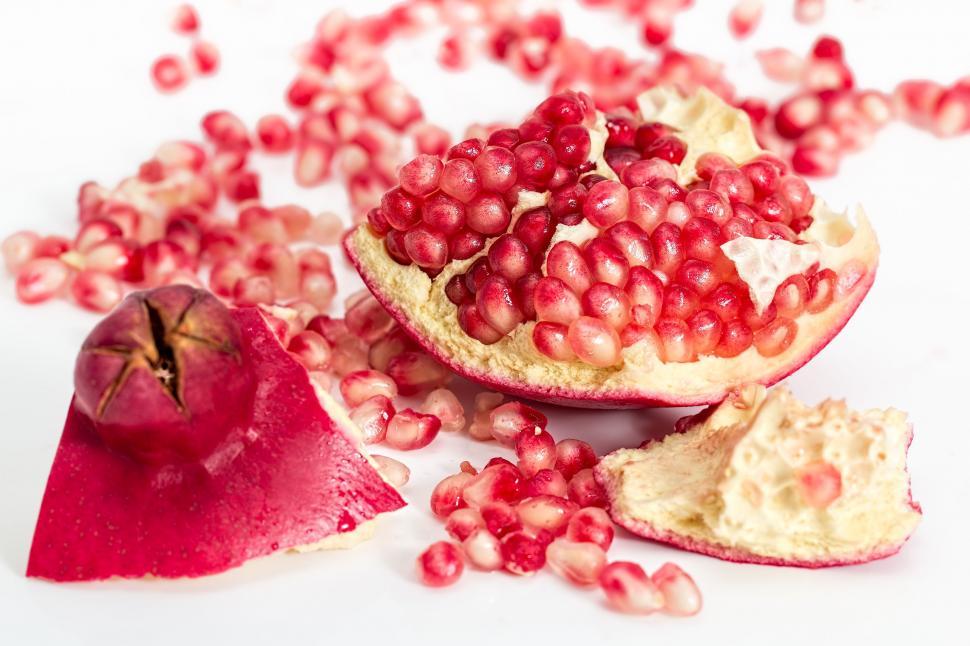 Ripe pomegranate cut in half showing juicy seeds