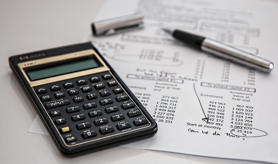 Free Image of Calculator on Pile of Paper 