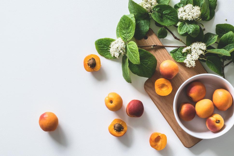 Free Image of Apricots with wooden board on table - white background  