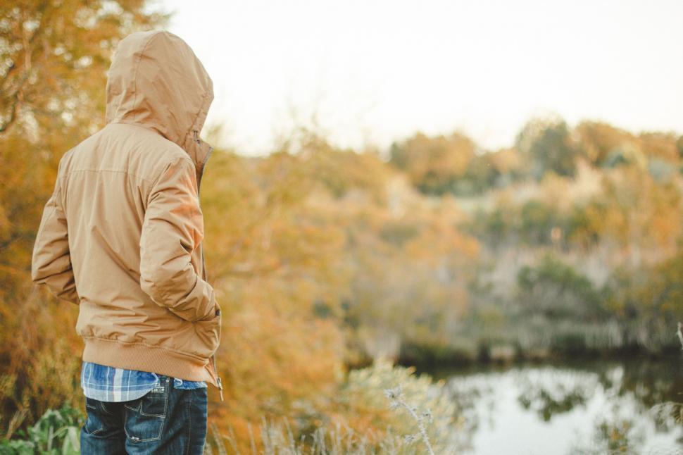 Free Image of Man in Jacket looking on the autumn trees  