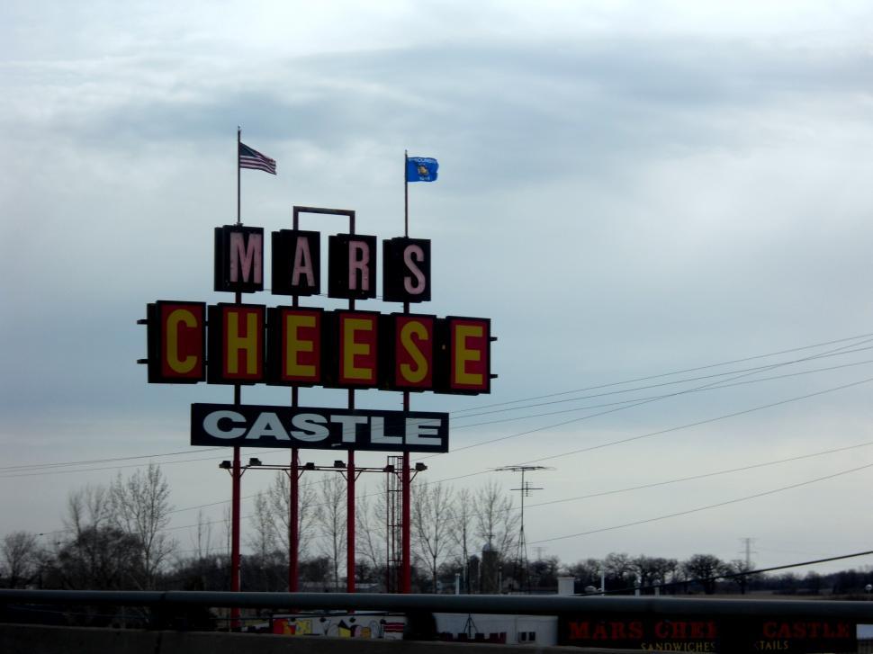 Free Image of Large Cheese Castle Sign on a Cloudy Day 