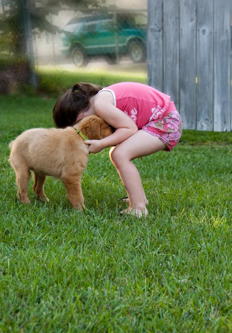 Free Image of Child playing with puppy 