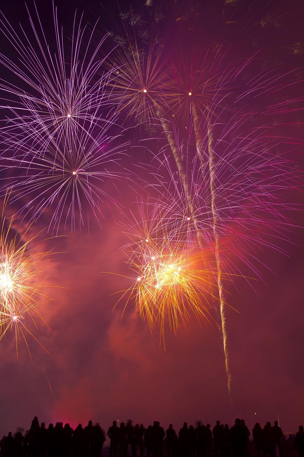 Free Image of Silhouetted People and Fireworks  