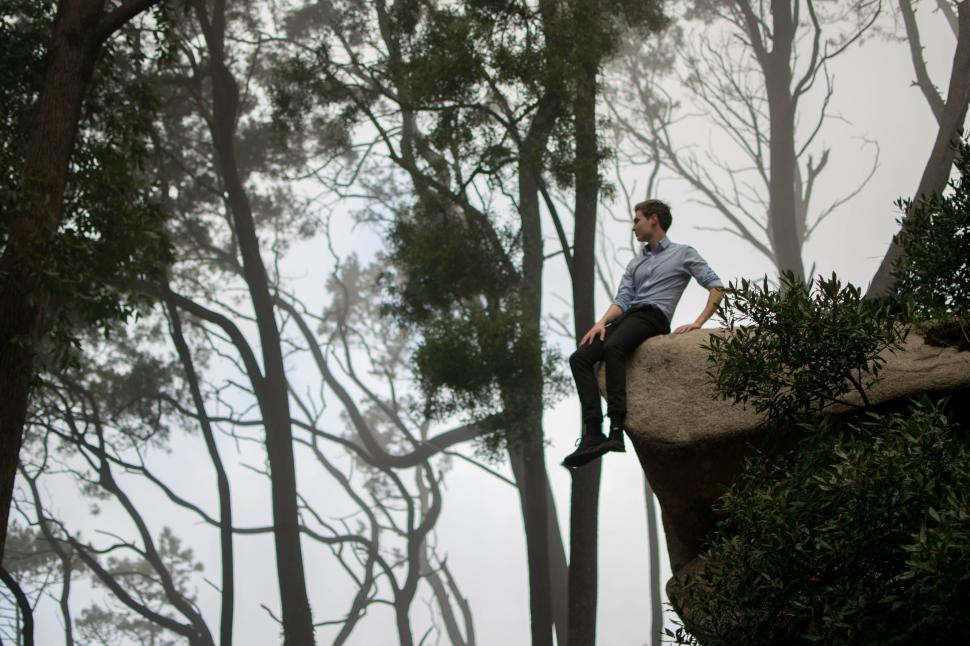 Free Image of Businessman Sitting on Rock 
