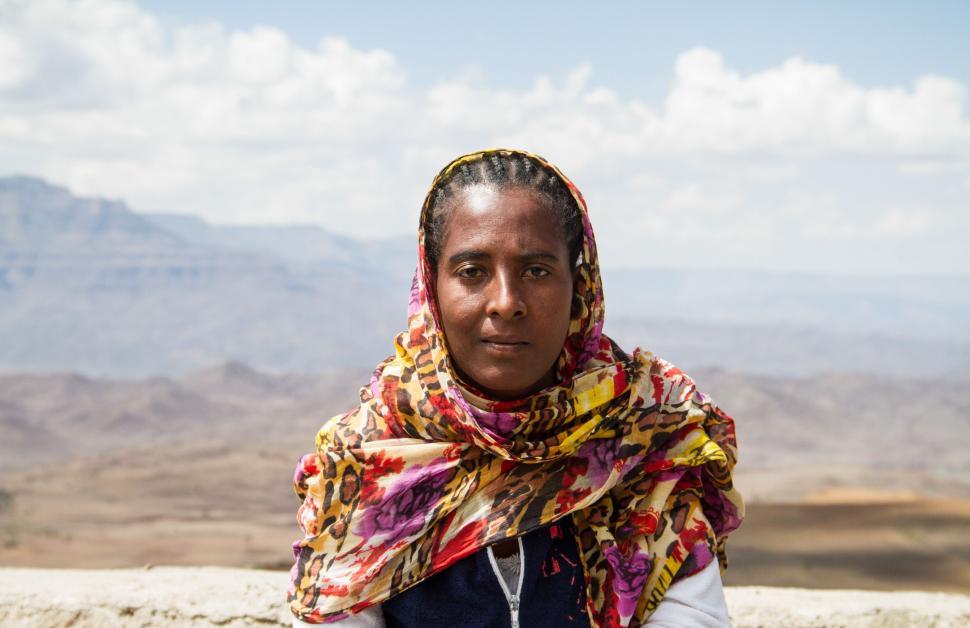 Free Image of Woman in Scarf with mountains as background  