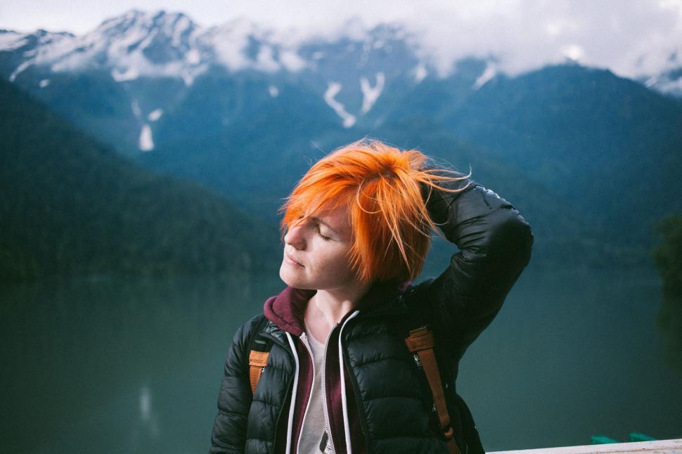 Free Image of Portrait of red short hair woman with lake and mountains as background - Looking away  