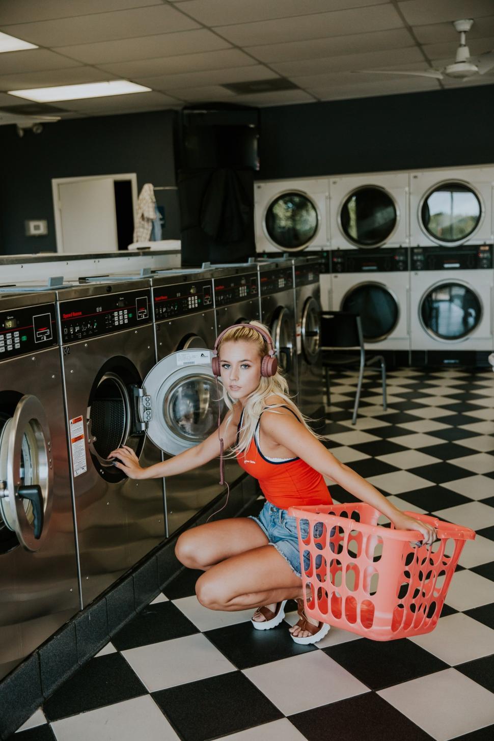 Free Stock Photo of Urban Woman with headphones at laundromat