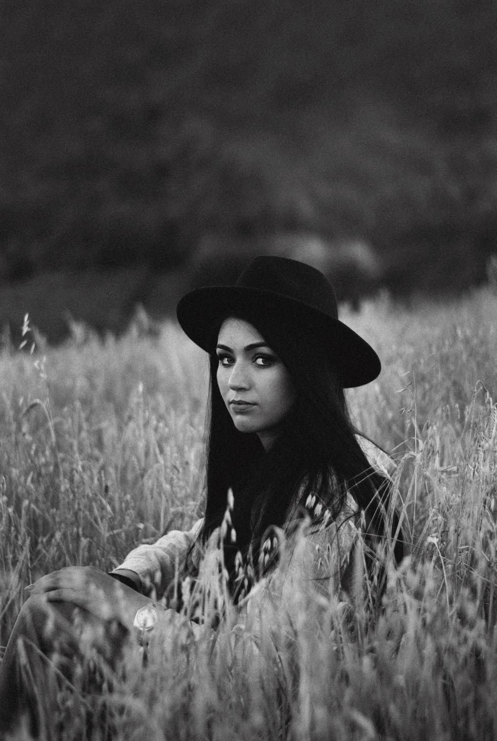 Free Image of Woman in hat looking at camera  