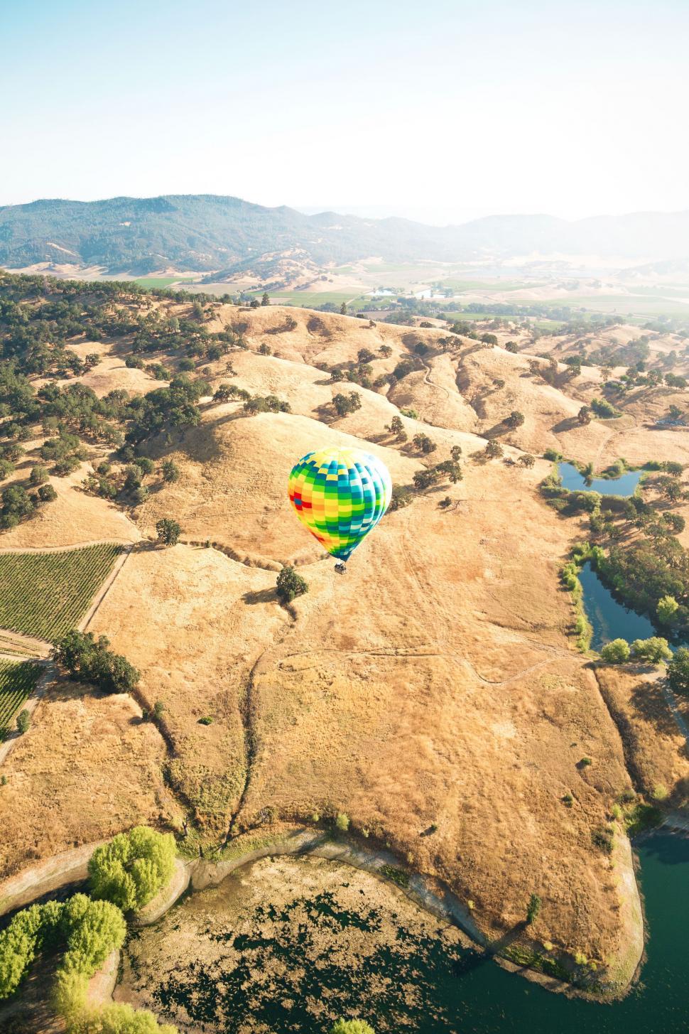 Free Stock Photo of Hot Air Balloon over hill Download Free Images