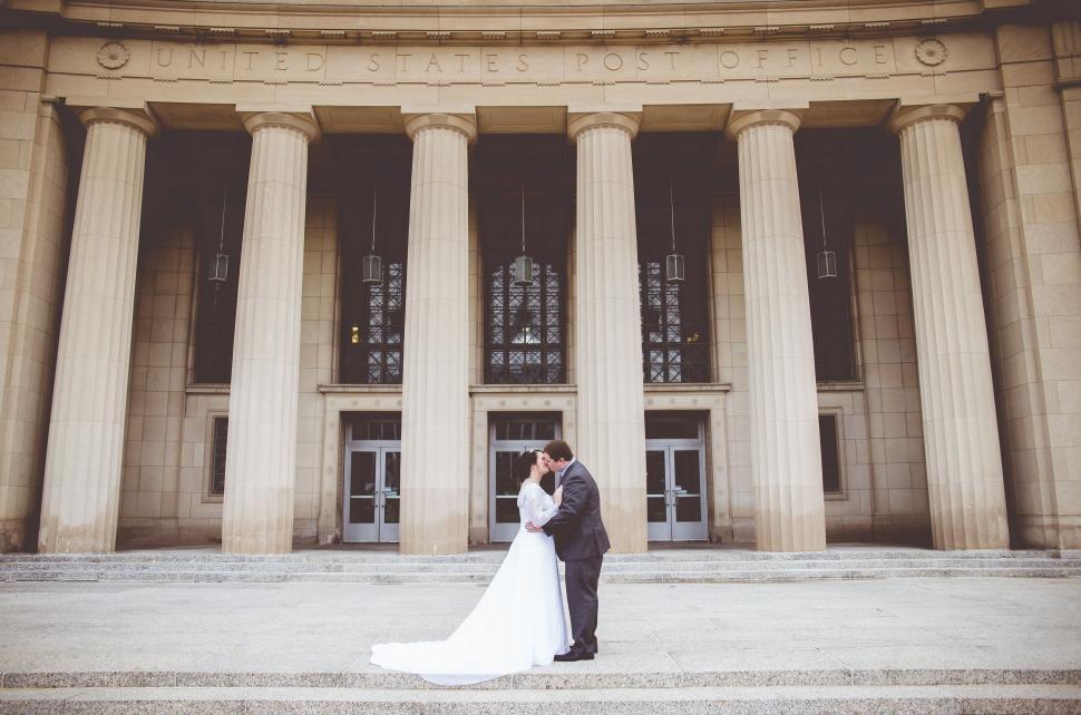 Free Image of Couple Kissing outside a building  