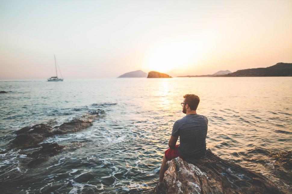 Free Image of Man on rock near ocean  