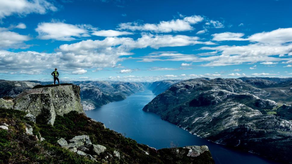 Free Image of Man on cliff with river  