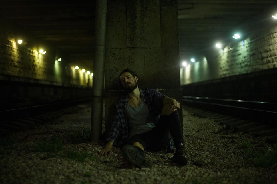 Free Image of Young Man resting inside tunnel 
