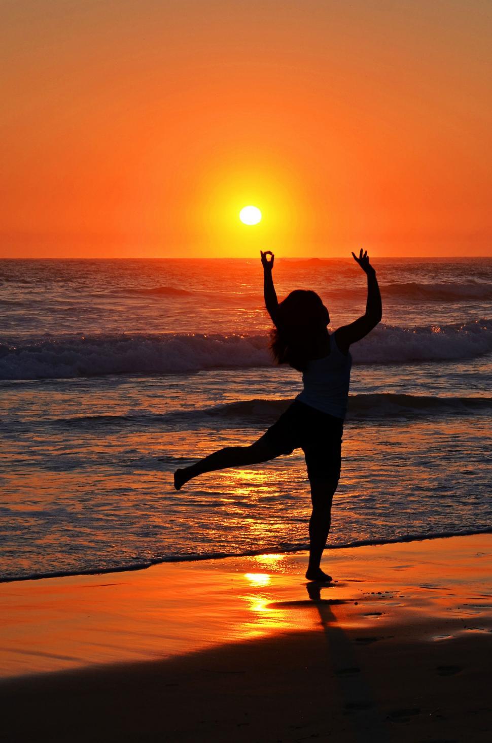 Free Stock Photo of Woman Dancing at the beach during sunset