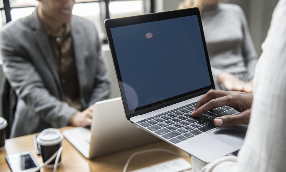 Free Image of Close up of a woman s hands typing on the laptop with blank screen 