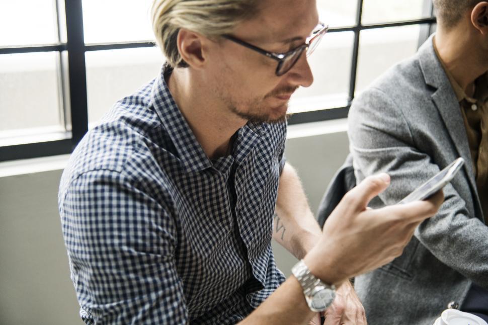 Free Image of A bearded man with a phone in the office 