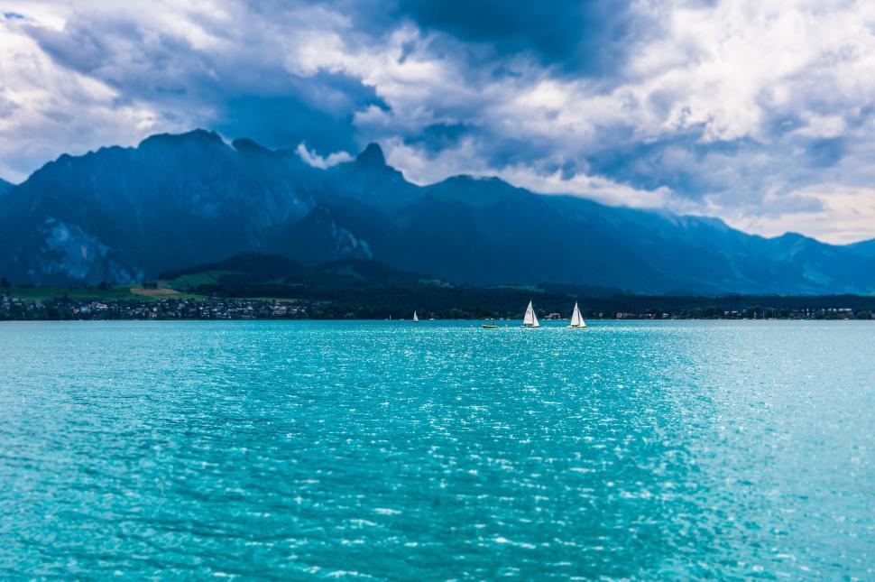 Free Image of Sailboats in Ocean with cloudy sky  