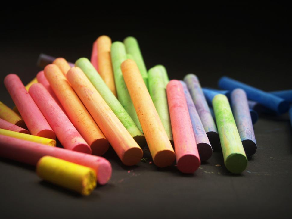 Premium Photo  Pile of multi color chalk on blue