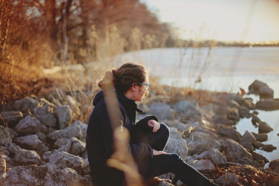 Free Image of Alone Woman Sitting At Seashore  