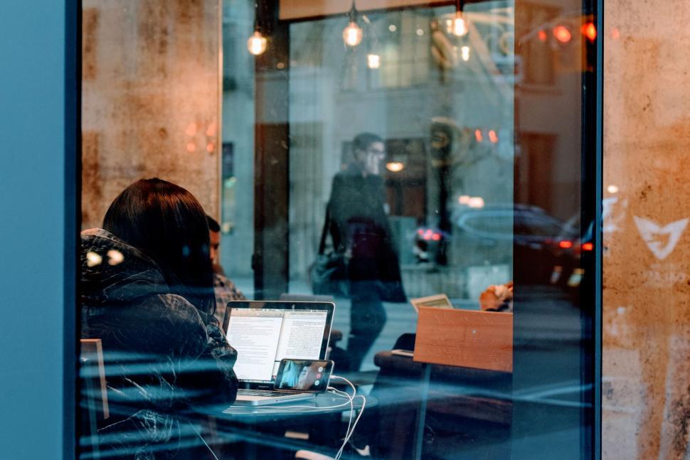 Free Image of Woman Working on Laptop in a restaurant 