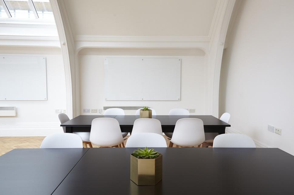 Small Conference Room With Whiteboard On Blue Wall Stock Photo