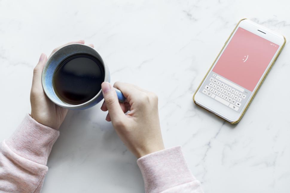 Free Image of Overhead view of a cup of coffee in a person s hands 
