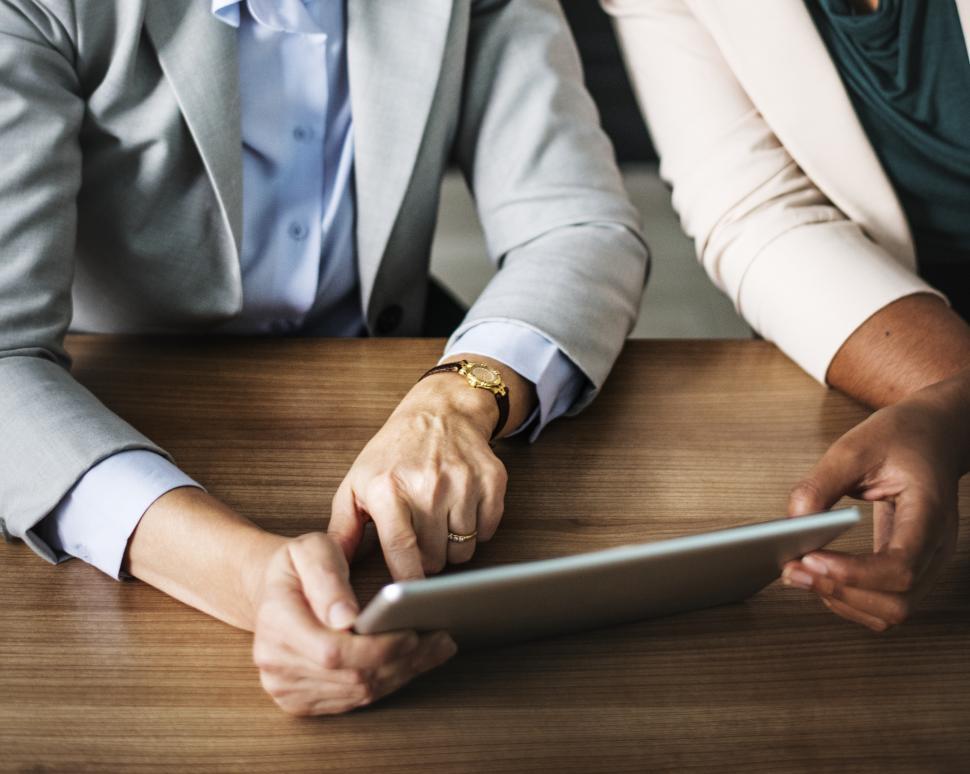 Free Image of Close up of people holding and interacting with a tablet PC 