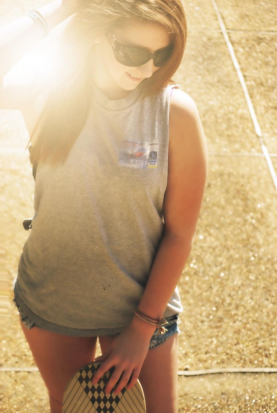 Free Image of Stylish Woman With Skateboard in Sunlight  