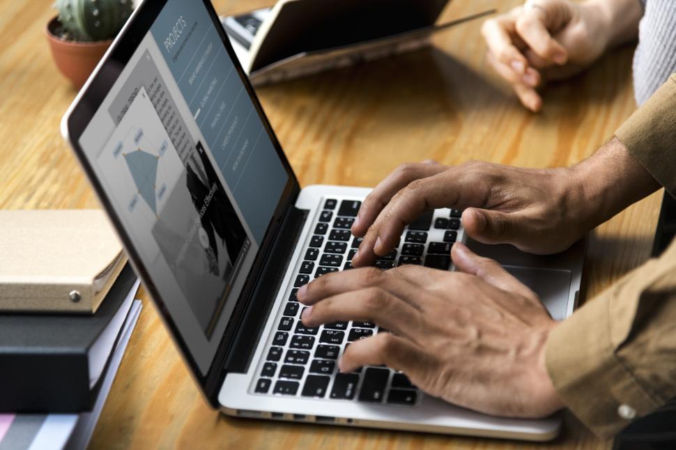 Free Stock Photo of Close up of a persons hands typing on a modern ...