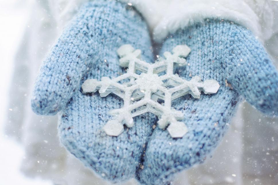 Free Image of Christmas Snowflakes and Hands in Snow  