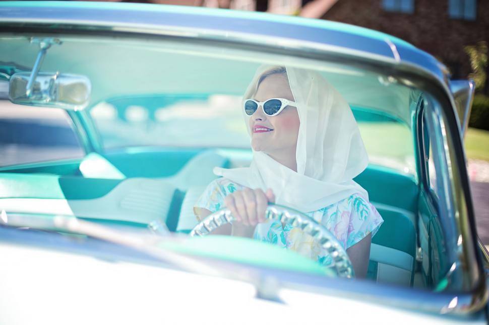 Smiling woman with sunglasses driving car stock photo