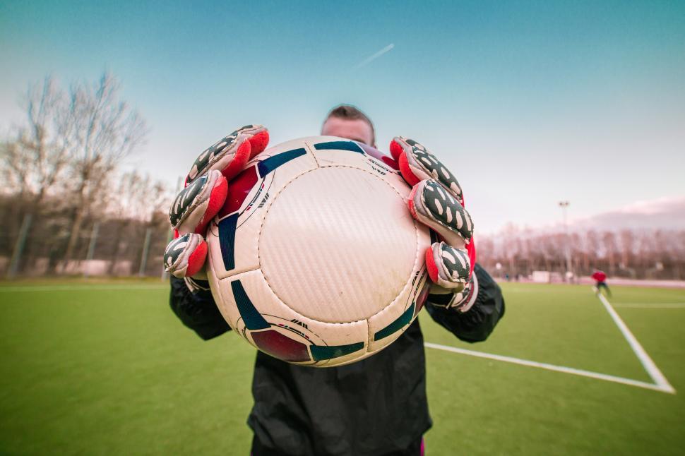 Free Image of Goalkeeper holding and showing football to the camera 