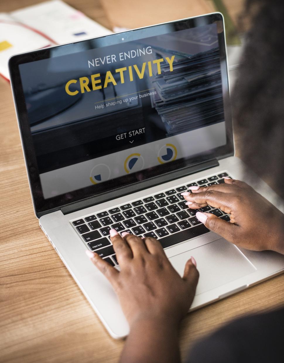 Free Image of Close up of a woman typing Creativity on the laptop 