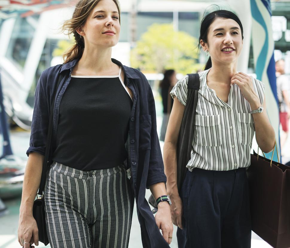 Free Image of Two young women walking and shopping 