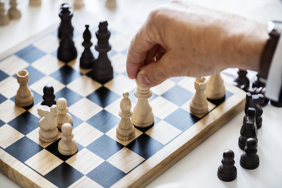 hand playing chess