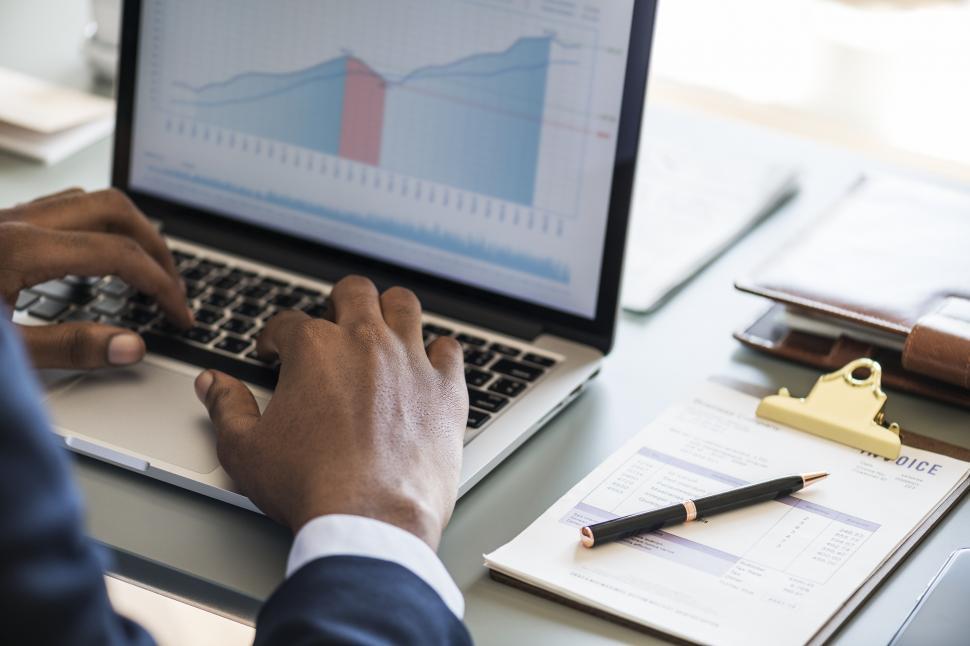 Free Image of Close up of a person working with business charts 