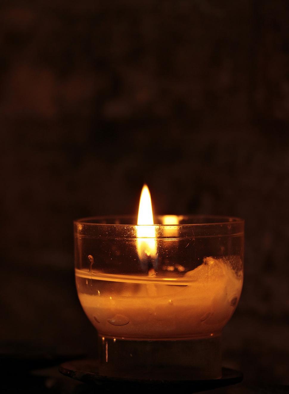 Lit tea candles and candles with copy space on black background Stock Photo  by Wavebreakmedia