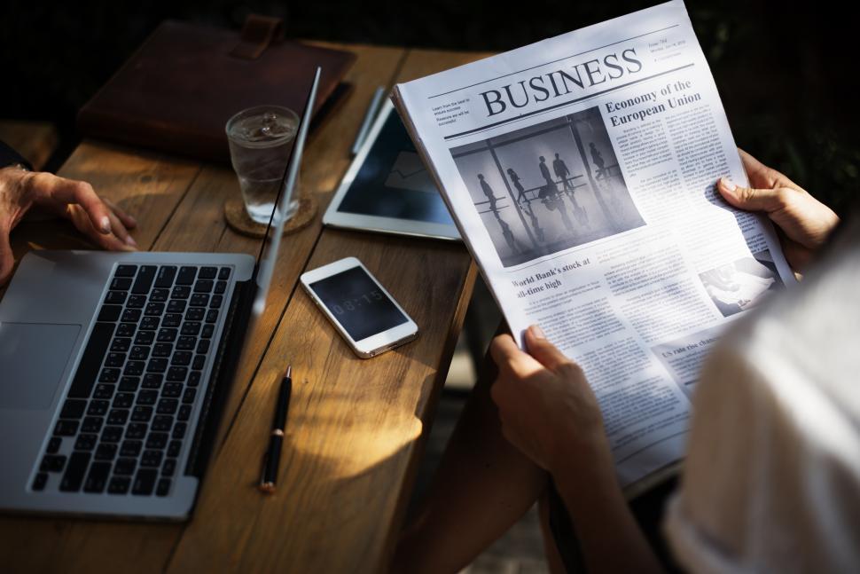 Free Image of Close up of two business people discussing news at an outdoor restaurant table 