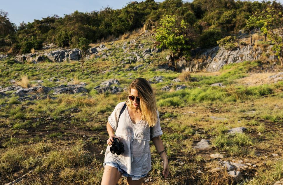 Free Image of A young hiker taking photos in the forest 