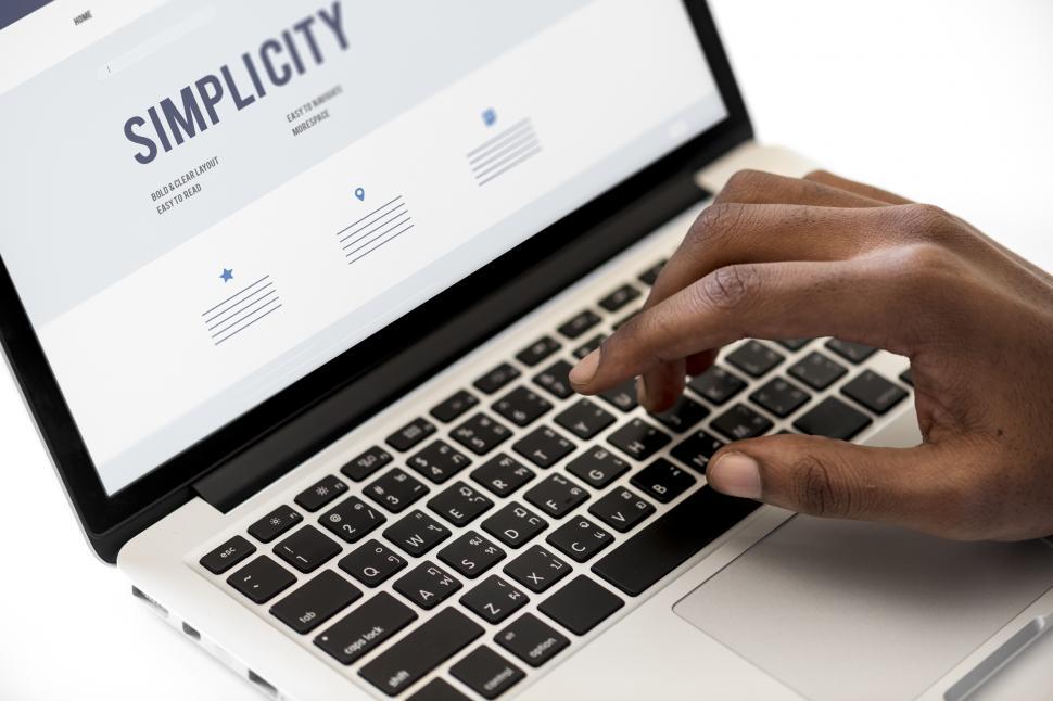Free Image of A person typing on an open laptop computer 