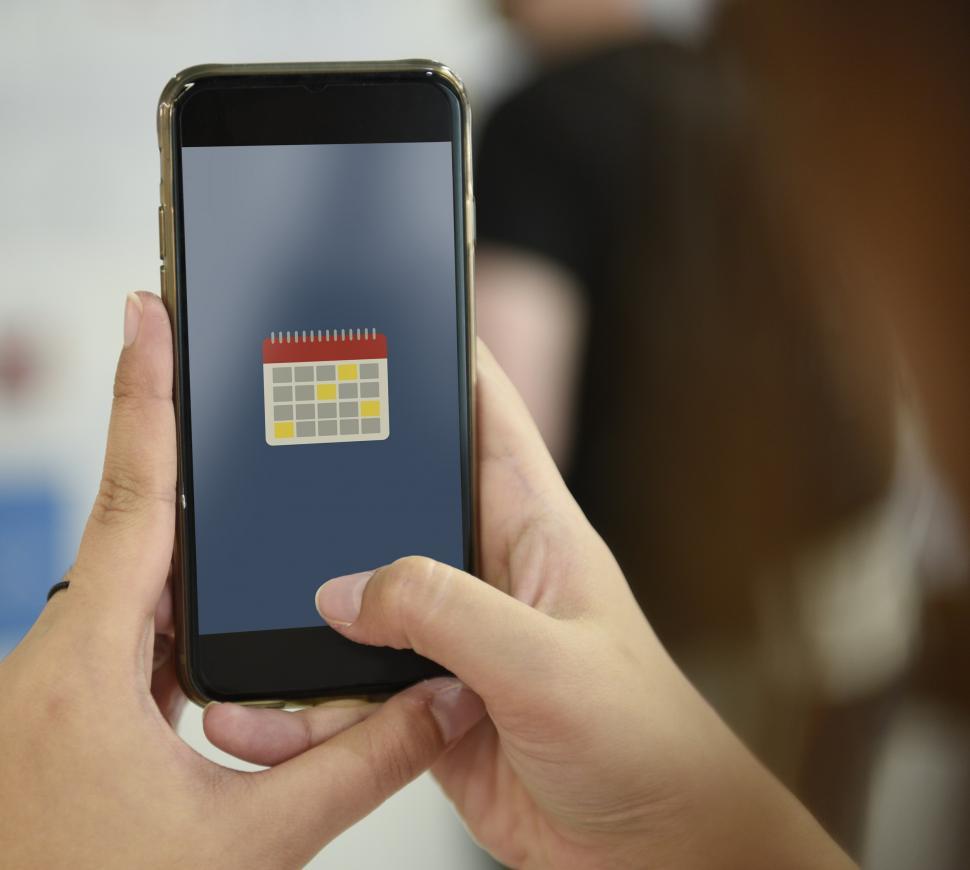 Free Image of Close up of a smart phone in a person s hands showing calendar 