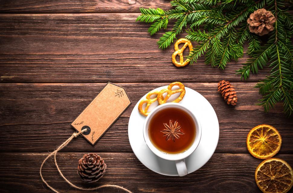 Free Image of Overhead view of a cup of herbal tea with star anise fruit on the saucer 