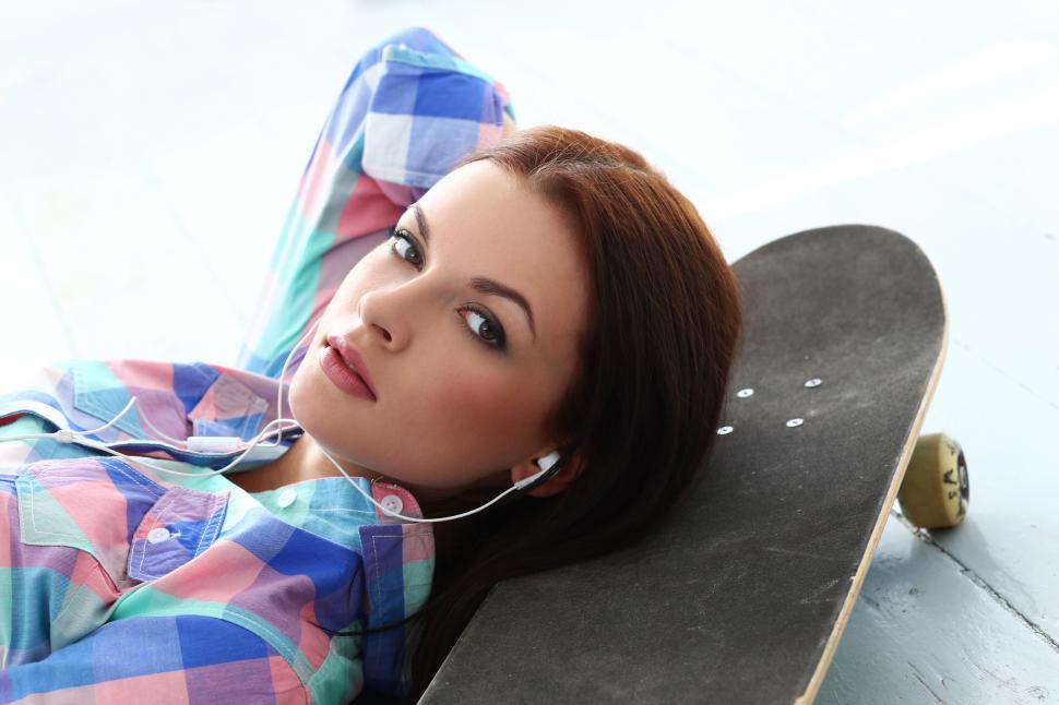Free Image of Girl with skateboard looking at camera 