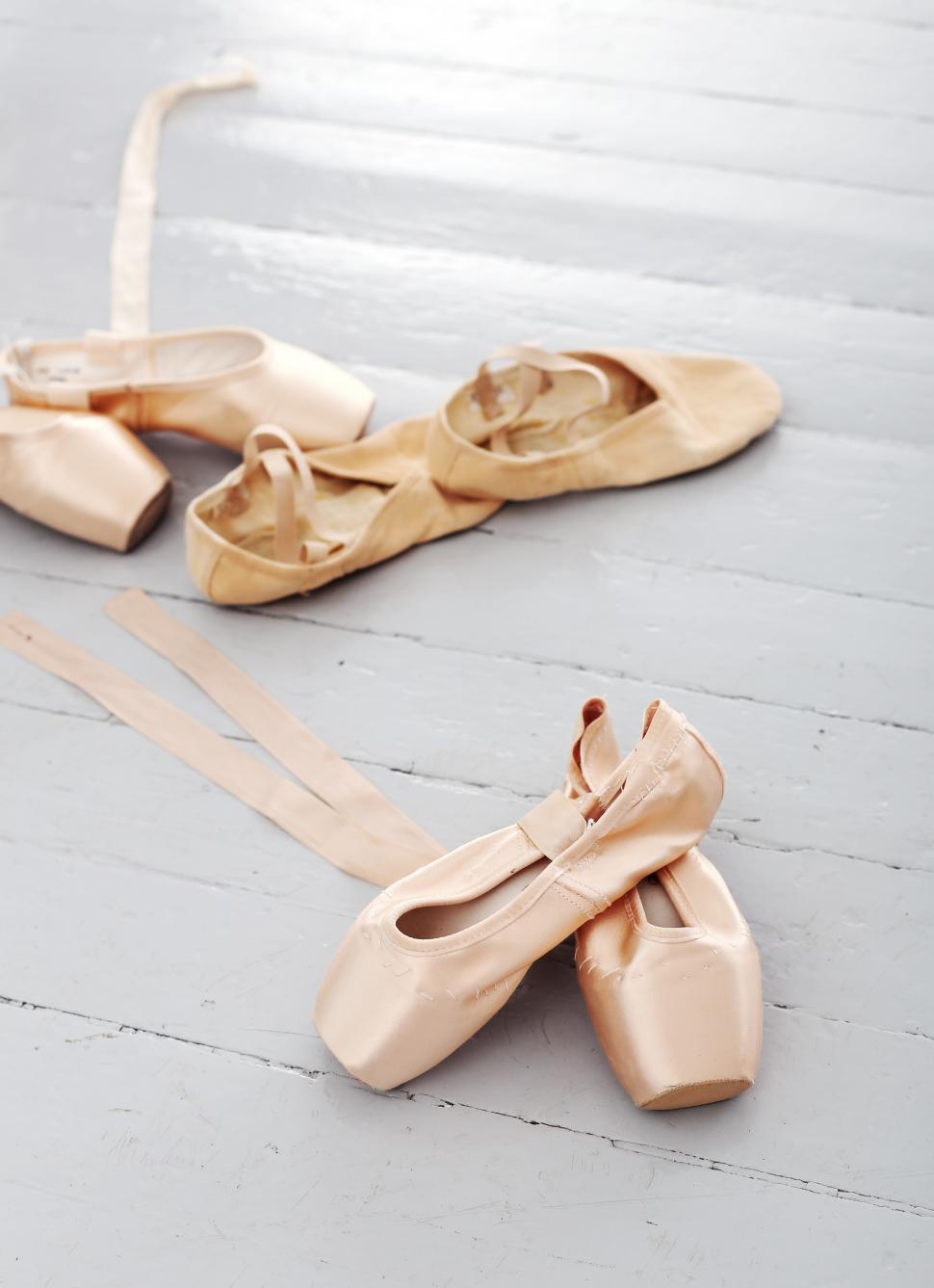 Ballet shoes lay alone on the floor
